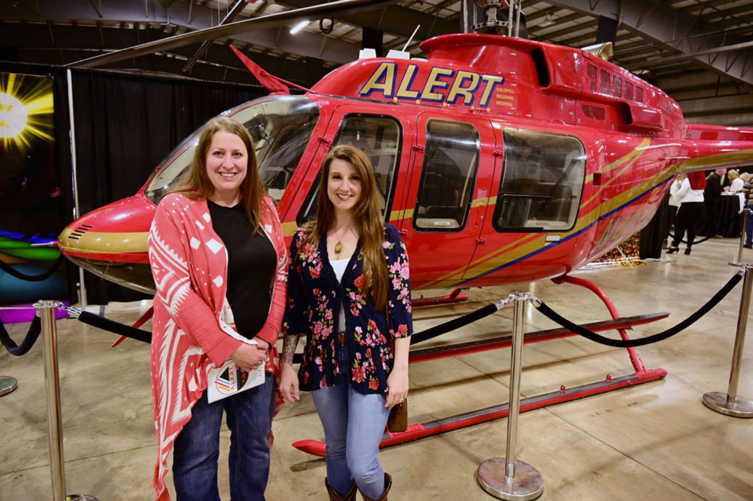 Employees standing next to mercy flight helicopter